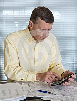 Senior man preparing USA tax form 1040 for 2012