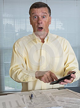 Senior man preparing USA tax form 1040 for 2012