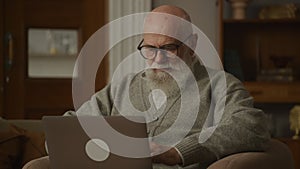 Senior Man Putting On Glasses, grandpa working on laptop