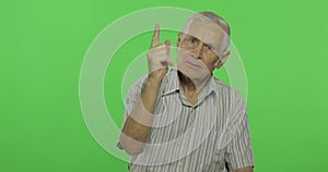 Senior man quarrels at someone. Handsome old man on chroma key background