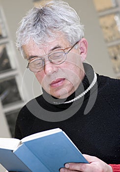 Senior man reading book