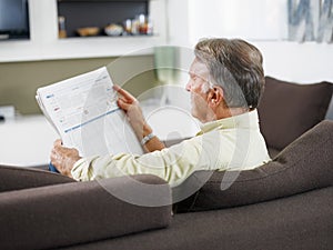 Senior man reading newspaper