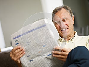 Senior man reading stock listings