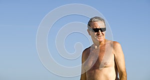 Senior Man relaxing in the beach photo