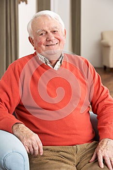 Senior Man Relaxing In Chair At Home