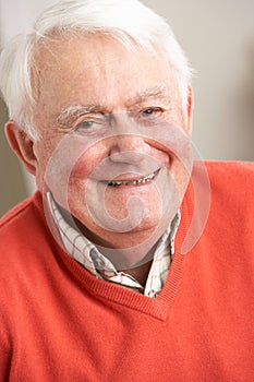 Senior Man Relaxing In Chair At Home