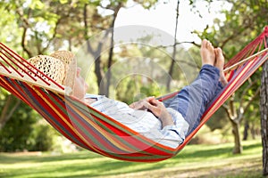 Senior Man Relaxing In Hammock