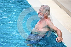 Senior man Relaxing in swimming pool. take a break , rest , retirement,workout,fitness,sport,exercise , copy space