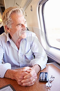 Senior Man Relaxing On Train Journey