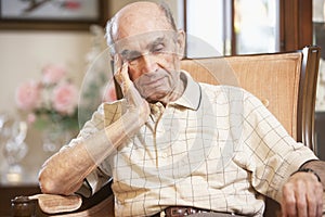 Senior man resting in armchair