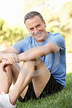 Senior Man Resting After Exercising In Park