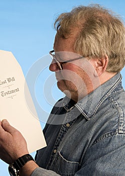 Senior man reviewing last will testament docume