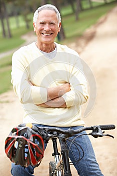 Senior man riding bicycle in park