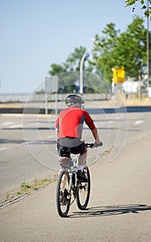 Senior man riding a bike in city jungle