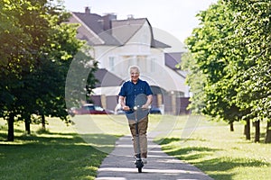 Senior man riding electric kick scooter