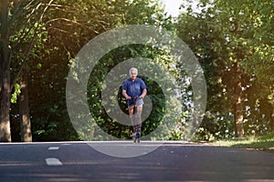 Senior man riding electric kick scooter