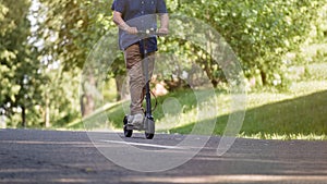 Senior man riding electric kick scooter