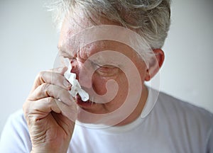 Senior man with runny nose photo