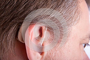 Senior man`s ear wearing hearing aid