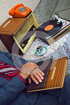 Senior man's hand touching an old photo album.