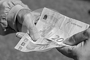 Senior man`s hands holding Euro banknote. Struggling pensioners