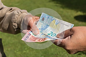 Senior man`s hands holding Euro banknote. Struggling pensioners