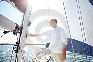 Senior man on sail boat or yacht sailing in sea