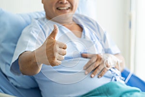 Senior man showing thumb up in hospital