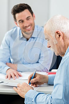 Senior man signing document