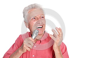 Senior man singing into microphone