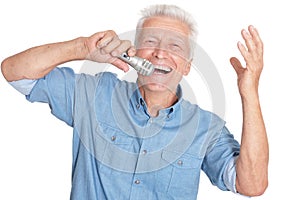 Senior man singing into microphone