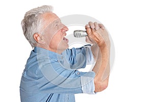 Senior man singing into microphone