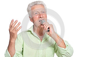 Senior man singing with microphone on white background