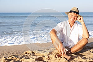 Senior man sitting on beach relaxing