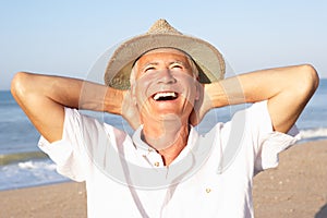 Senior man sitting on beach relaxing