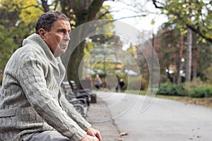 Senior man sitting on bench in the park