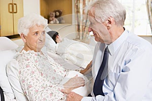 Senior Man Sitting With His Wife In Hospital