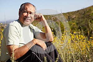 Senior man sitting outdoors