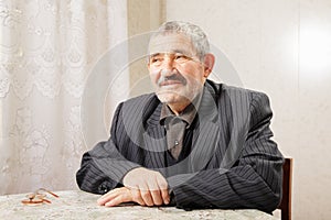 Senior man sitting at table