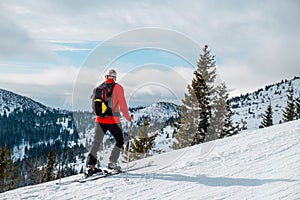 Senior man ski tour walking up looking on landscape