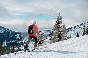 Senior man ski tour walking up looking on landscape