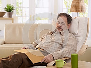 Senior man sleeping in armchair