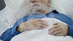 Senior man sleeping in bed and snoring, problems with sleep, health care