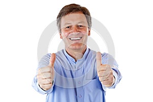 Senior man smiles happy and shows both thumbs up