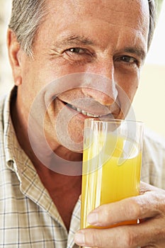 Senior Man Smiling Drinking Orange Juice