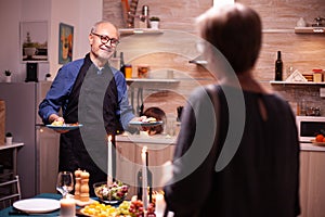 Senior man smiling at wife