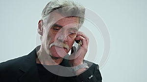 Senior man speaking on mobile phone