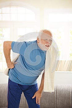 Senior man in sportswear having pain in back