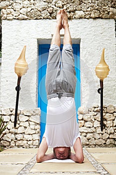 Senior Man Standing On Head In Yoga Position