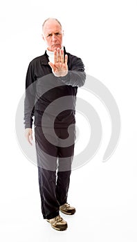 Senior man stopping with hand gesture